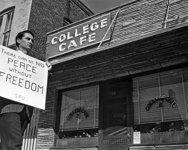 A UNC representative of the Student Peace Union pickets the segregated College Cafe.
