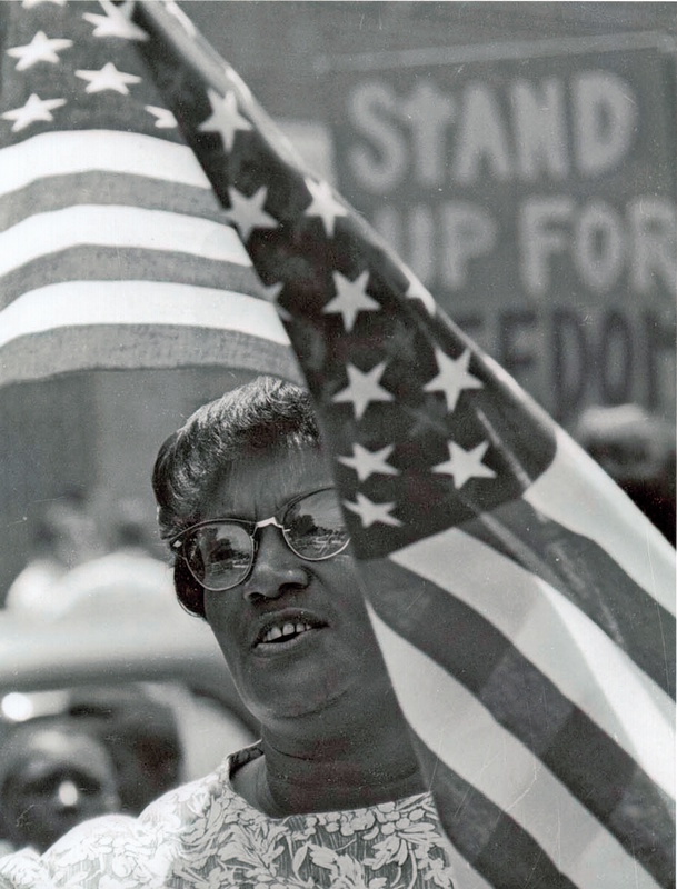 Mrs. Betty Jones marches in a protest on Independence Day