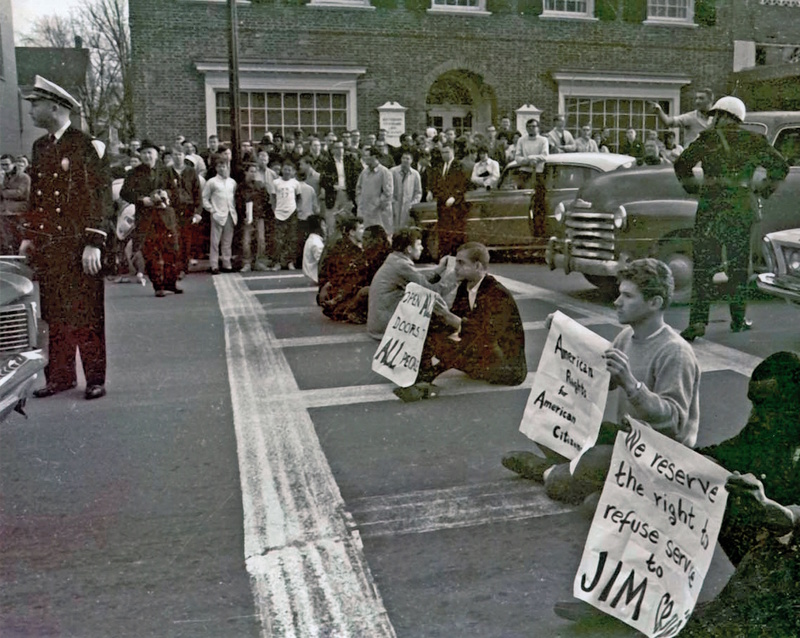 Protestors plant themselves in a crosswalk on Franklin Street